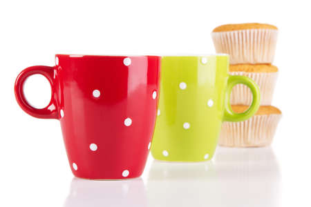 Two cups of tea with muffins isolated on whiteの写真素材