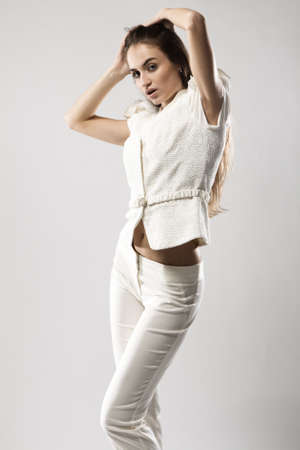 Fashion model in stylish dress, studio portrait