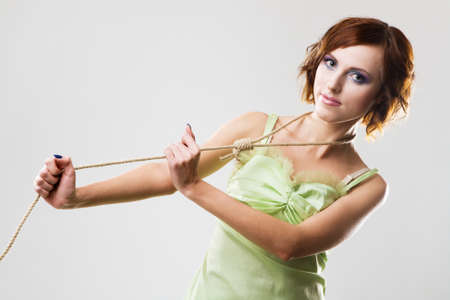 Beautiful woman with hangman's noose, studio photoの写真素材