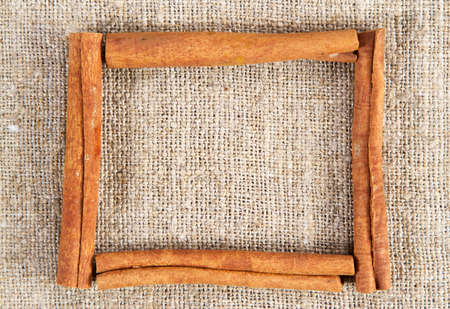 Cinnamon sticks frame on a sacking clothの写真素材