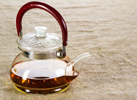 Tea pot on a rough cloth studio pictureの写真素材