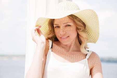 Beautiful lady in a hat on a sunny dayの写真素材