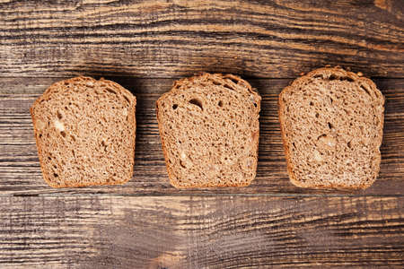 Slices of brown bread on a wooden table