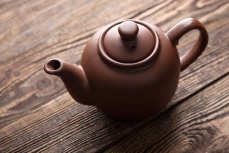 Teapot on a wooden table - studio still lifeの写真素材