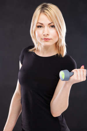 Young woman working out with dumbbellsの写真素材