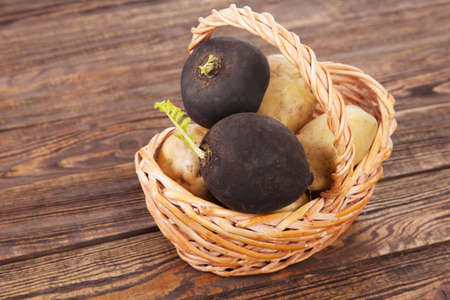 Black radish on a wooden tableの写真素材