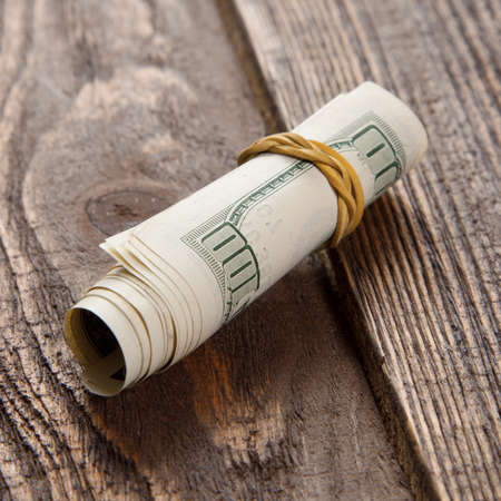 Dollar bills on a wooden tableの写真素材
