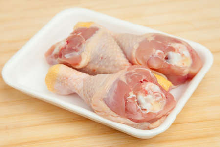 Raw chicken on a kitchen tableの写真素材