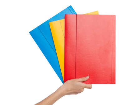 Female hand holding a folder, white backgroundの写真素材