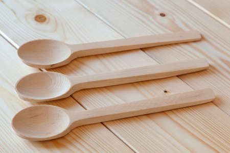 Wooden spoons on a tableの写真素材