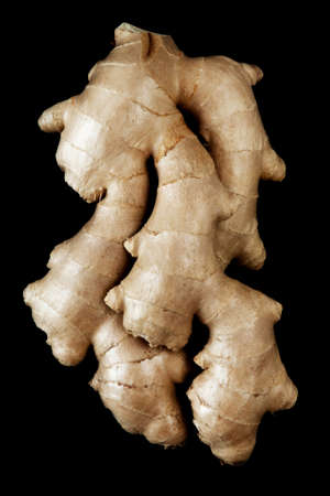 Fresh ginger root on black background