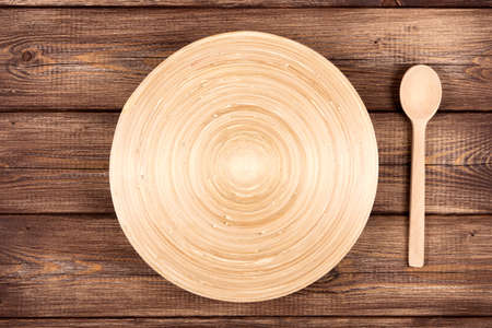 Empty plate on a wooden tableの写真素材
