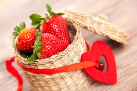 Fresh strawberries in a wicker basketの写真素材