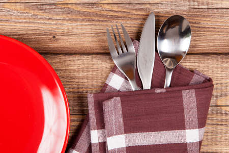 Red plate on a wooden tableの写真素材