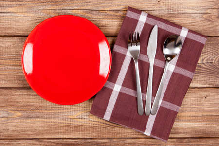 Red plate on a wooden tableの写真素材