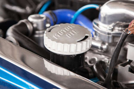 Motor oil cap under the hood of a car