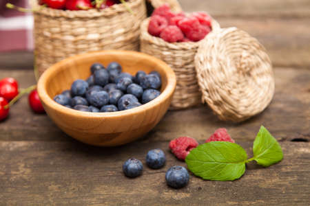 Fresh berries on a wooden tableの写真素材