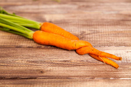 Raw carrot on a wooden tableの写真素材