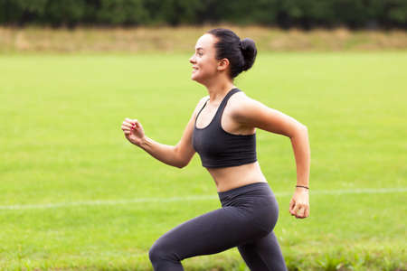 Young woman working out in a park