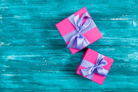 Pink gift boxes on blue woodの写真素材