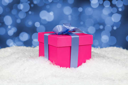 Christmas gift box in snowの写真素材