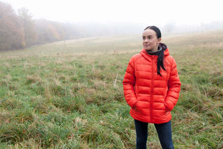 Young woman in a warm jacket in the woodsの写真素材