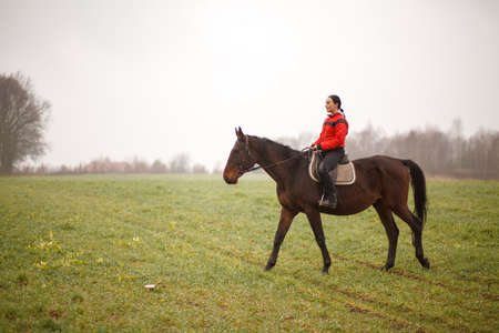 Young woman riding a horseの写真素材