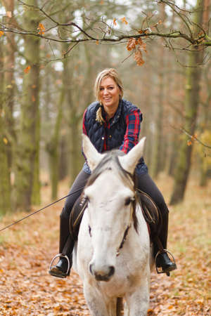 Young woman riding a horse