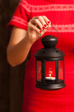 Female hands holding a lanternの写真素材