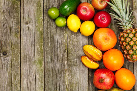 Set of colorful fruits on old wood background