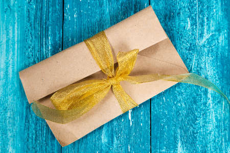 Paper envelope on blue wood surfaceの写真素材