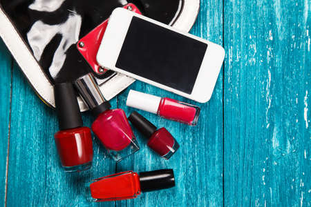 Nail polish on blue wood surfaceの写真素材