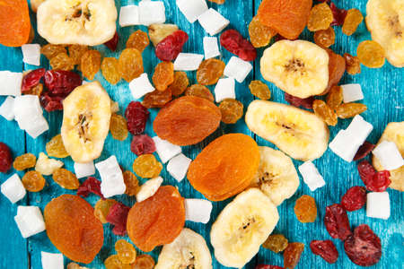 Dry fruit on blue wood backgroundの写真素材
