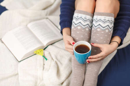 Female legs in warm woolen socks.
