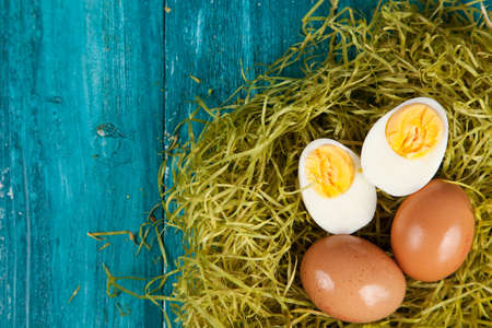 Organic eggs on blue wood background.の写真素材