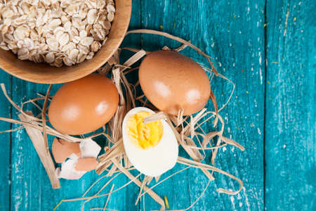 Organic eggs on blue wood background.