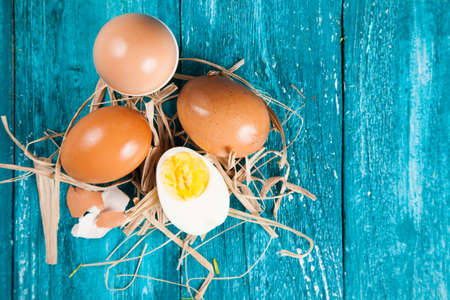 Organic eggs on blue wood background.の写真素材