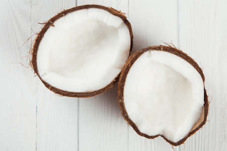 Cracked coconut on wooden table.の写真素材