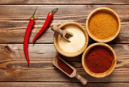 Assortment of spices on a wooden table.の写真素材