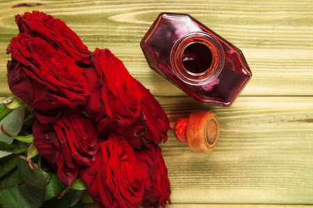 Beautiful red roses on wooden surfaceの写真素材