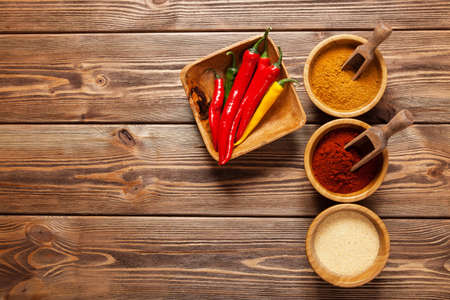 Bowls with spices on wooden tableの写真素材