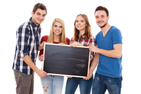 Group of happy young people holding a blackboardの写真素材