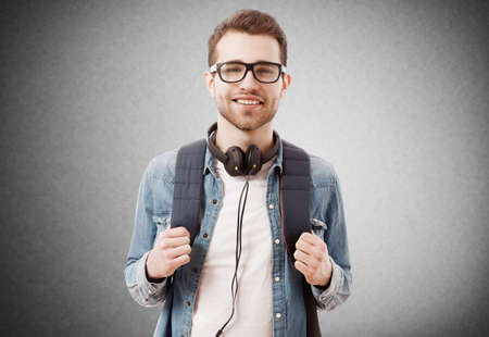 Portrait of a young man on grey backgroundの写真素材