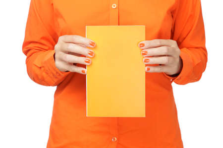 Woman in orange shirt holding a bookの写真素材