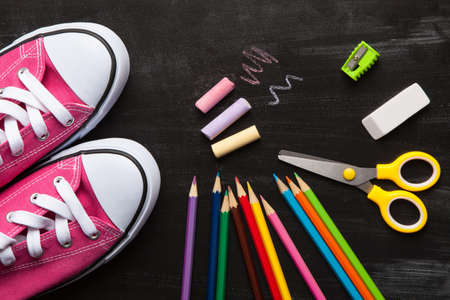 School and office accessories on blackboard surface