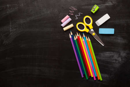 School and office accessories on blackboard surfaceの写真素材