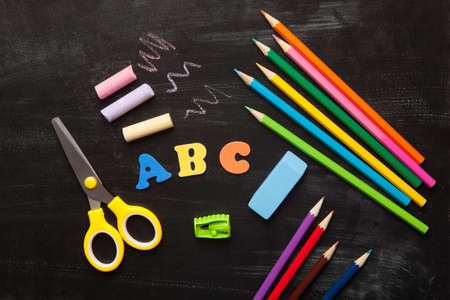 School and office accessories on blackboard surfaceの写真素材