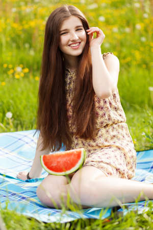 Young beautiful woman eating a watermelon.
