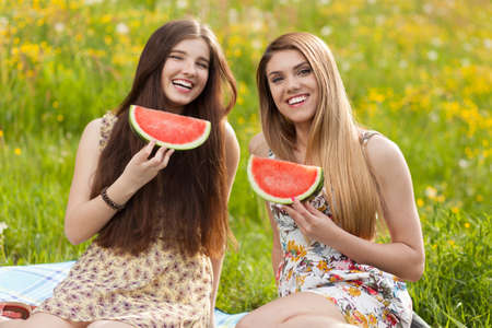 Two beautiful young women on a picnic.の写真素材