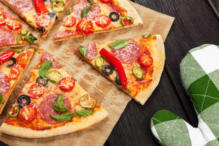 Delicious home made pizza on wooden backgroundの写真素材